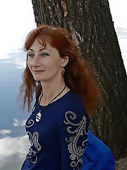 A beautiful mature woman is fondling her genital area